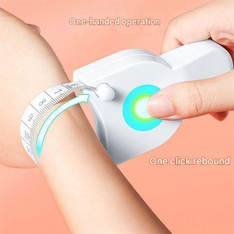 Handheld device with a measuring tape being used on a arm, on a pink background