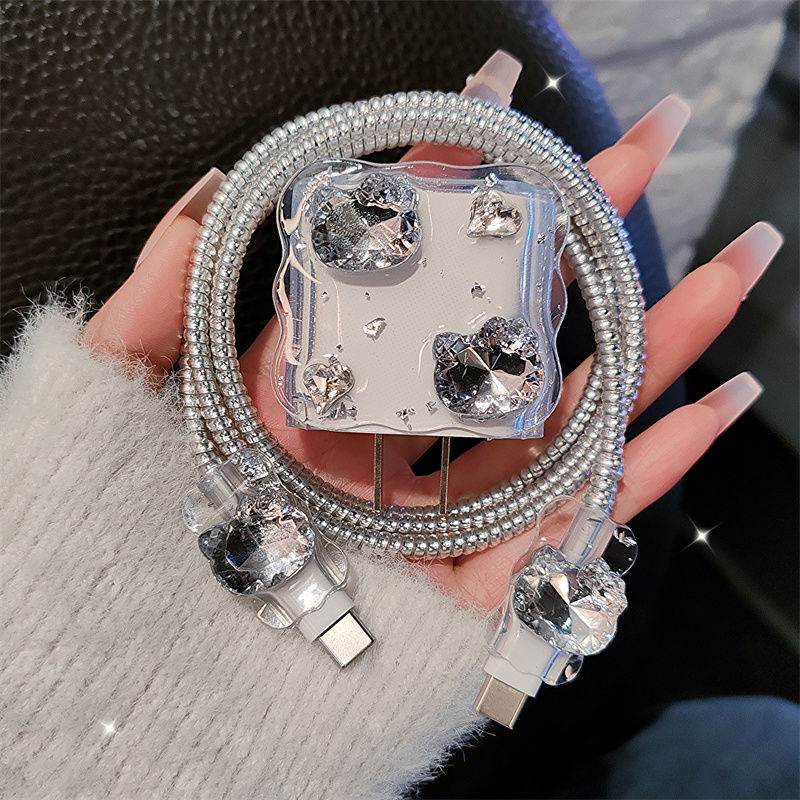 Phone case with rhinestones and USB cable held by a hand