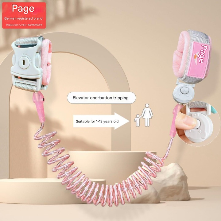 Pink and gray child leash with safety features on a beige background
