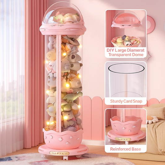 Pink display cabinet with transparent dome containing plush toys, placed against a pink wall.