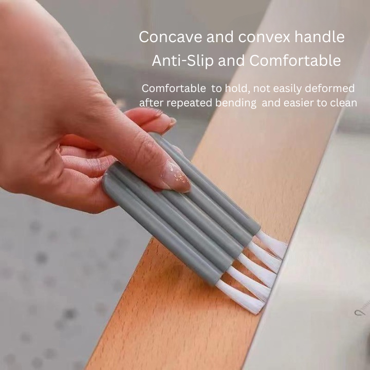 Person using a gray cleaning brush with white bristles on a wooden surface, text about handle design.