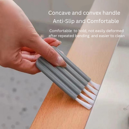 Person using a gray cleaning brush with white bristles on a wooden surface, text about handle design.
