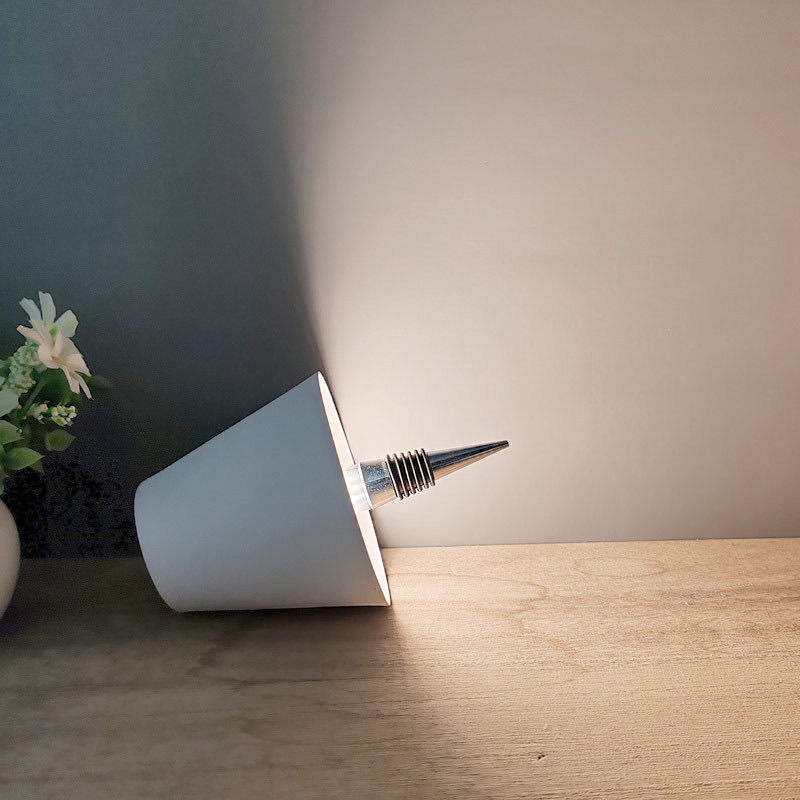 White pen light on a wooden surface with a soft background