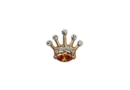 Gold crown-shaped jewelry with embedded stones on a white background