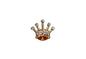 Gold crown-shaped jewelry with embedded stones on a white background