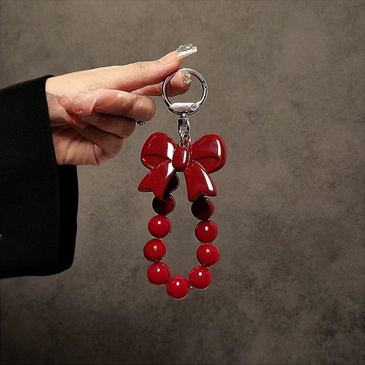 Luxury Black Phone Case with Red Bow Beaded Hand Strap – Stylish & Protective