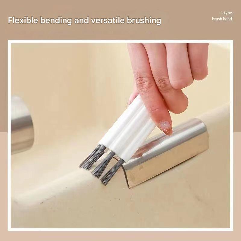 Hand holding a metal brush with bristle ends against a beige background