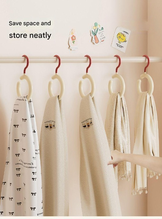 Hanging towels on a rack with text 'Save space and store neatly' against a beige background.