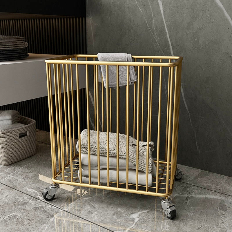 Gold metal towel rack with folded towels against a marble wall