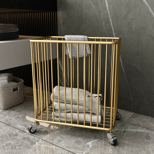 Gold metal towel rack with folded towels against a marble wall