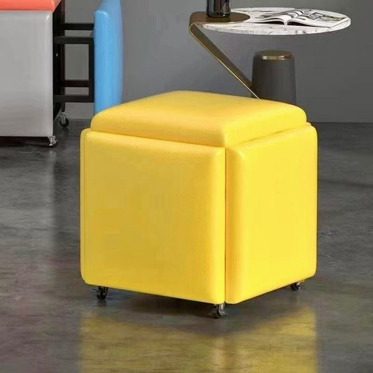 Yellow cube ottoman with storage compartments on a gray floor.
