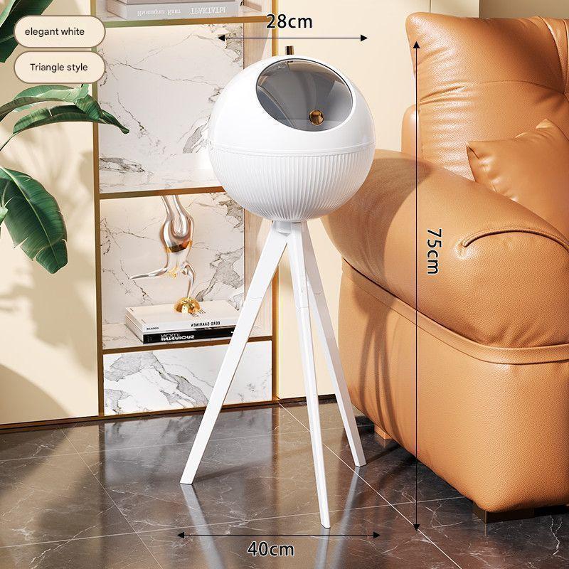 White decorative lamp on a tripod with measurements in a living room setting