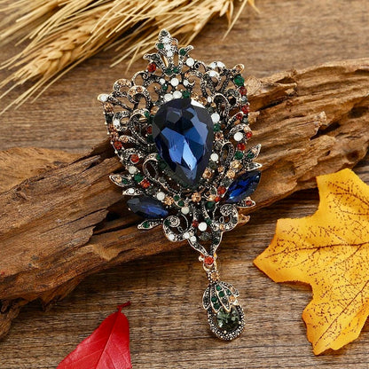 Opulent Crystal Statement Brooch – Exquisite Blue Teardrop Gem with Floral Crystal Detailing | Luxury Accent Brooch for Couture Styling