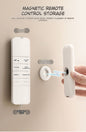 Magnetic remote control storage system with a hand demonstrating its use.